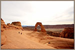 Two hikers leave Delicate Arch