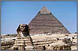 Sphinx with background of a pyramid.